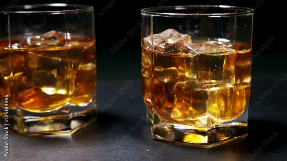 glasses of malt whiskey on a black table glasses of malt whiskey on a black table