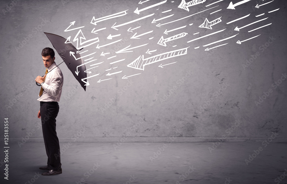 Business man standing with umbrella and drawn arrows hitting him Business man standing with umbrella and drawn arrows hitting him