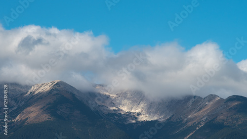 The picturesque mountain on the background of cloud stream. Wide angle