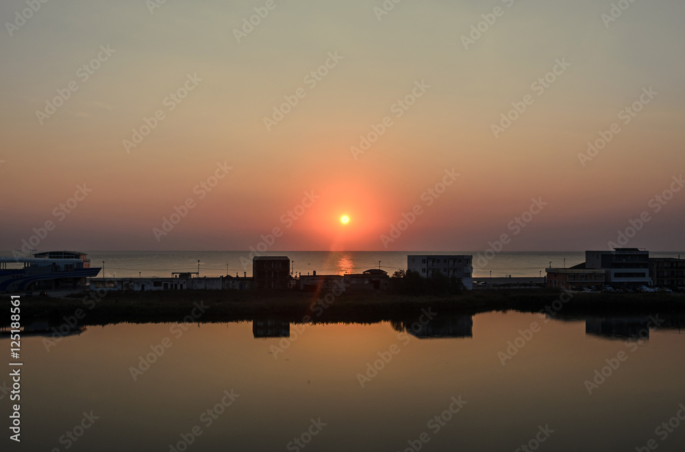 Sunrise on seaside, sand and clear water, the shore of Black Sea Sunrise on seaside, sand and clear water, the shore of Black Sea