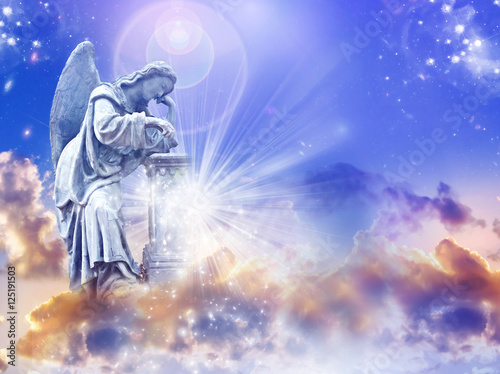 Angel archangel over mystical sky with rays of light and copy-space  photo