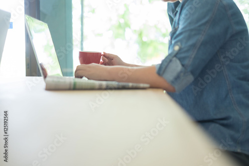 Businesswoman using laptop and on her office table