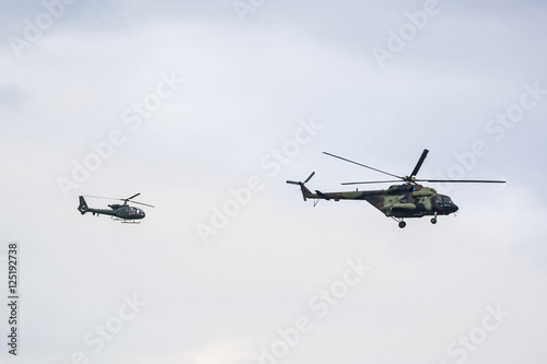 Fototapeta Naklejka Na Ścianę i Meble -  Two military helicopter on cloudy sky