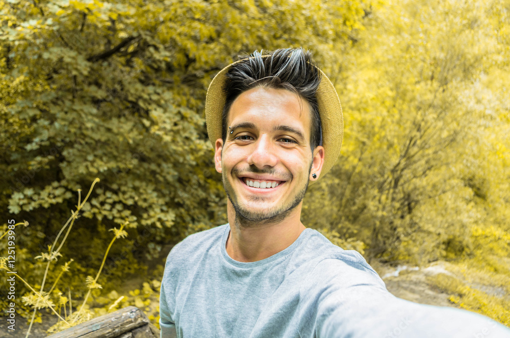 Handsome traveller man taking a selfie on his excursion Handsome traveller man taking a selfie on his excursion