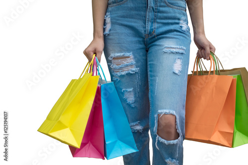 Happy shopping! Unrecognizable woman in orange pants holding multicolored shopping bags © kaisaya