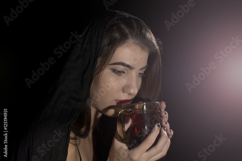 Young woman  studio portrait on black background