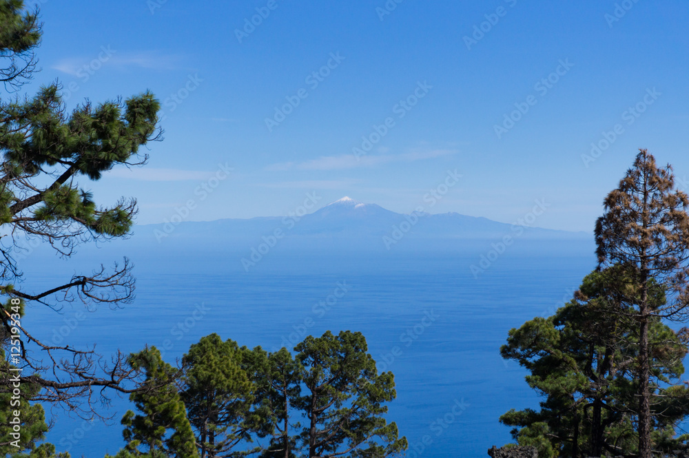 View from palma to neighbor island tenerife. The peak of vulcan Teide / Teyde is seen with white snow.