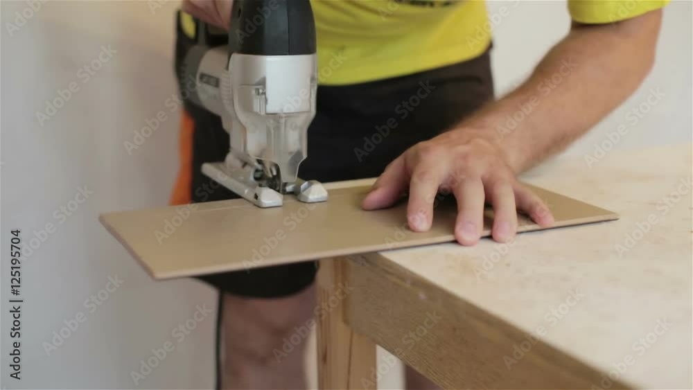 Man works with fretsaw and a wooden board. Man works with fretsaw and a wooden board.