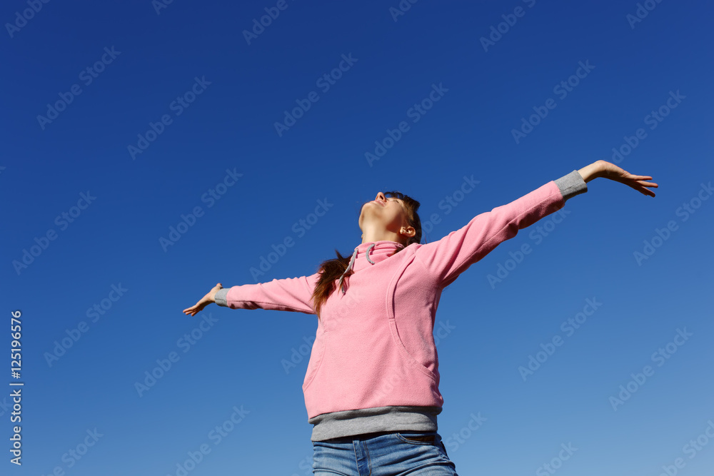 Beautiful young woman against the blue sky. Beautiful young woman against the blue sky.