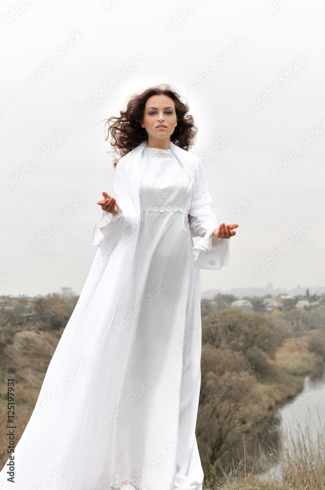 Girl stands on a hill protyashivaya hands to the camera Girl stands on a hill protyashivaya hands to the camera
