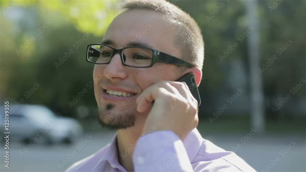 A happy man talking on the phone. A happy man talking on the phone.