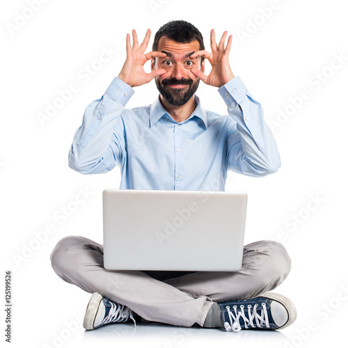 Man with laptop showing something