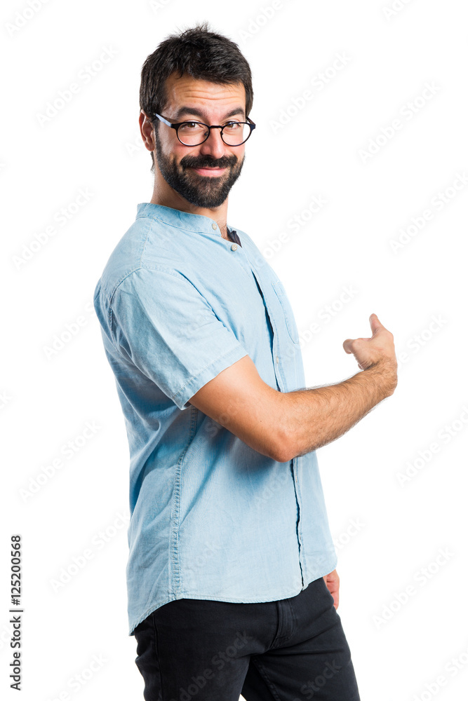 Handsome man pointing back