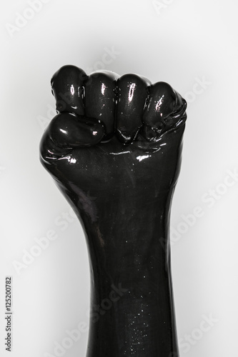 gesture of a hand wearing a black latex glove: fist