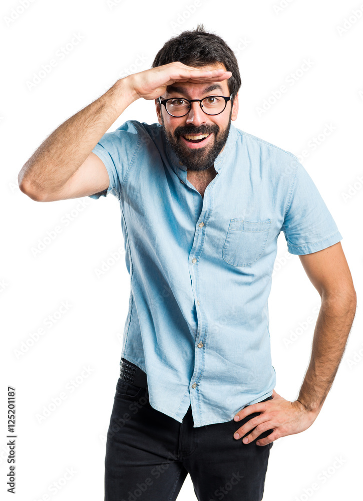 Handsome man with blue glasses showing something Handsome man with blue glasses showing something