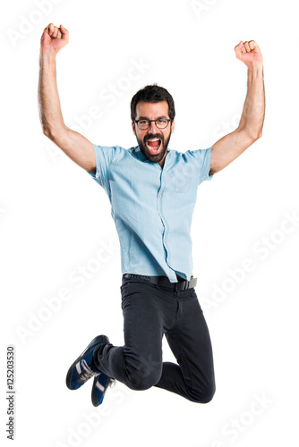 Handsome man with blue glasses jumping