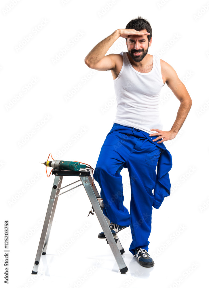 Young electrical technician with a drill showing something
