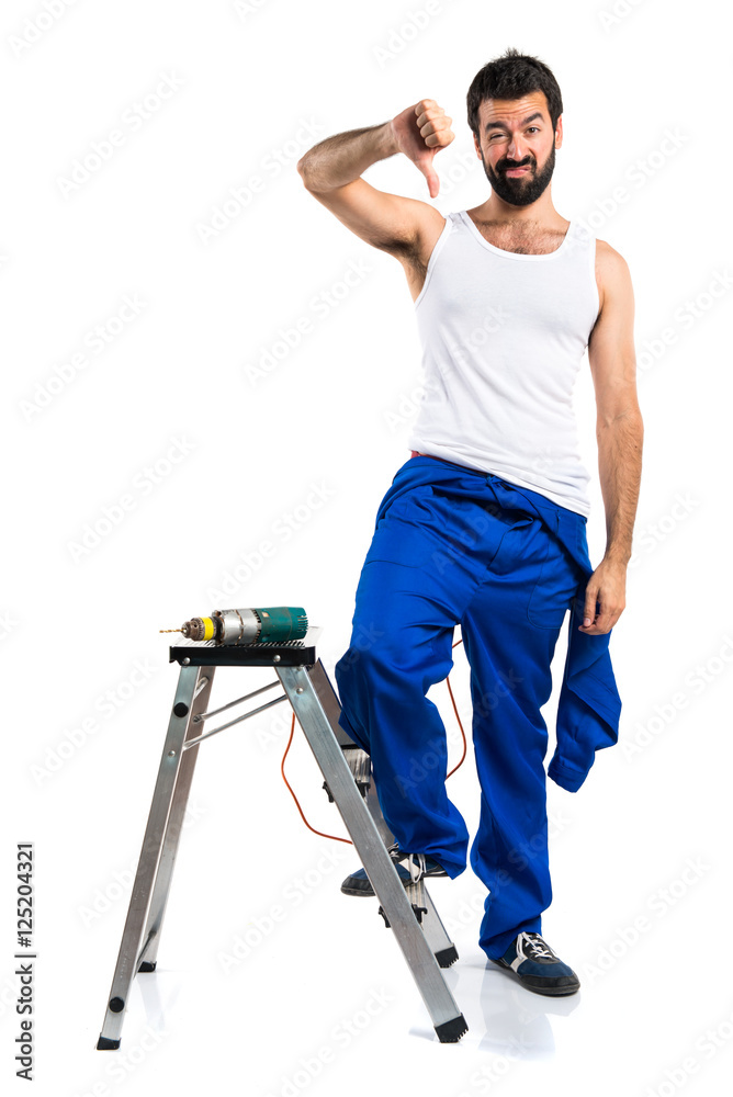 Young electrical technician with a drill doing bad signal Young electrical technician with a drill doing bad signal