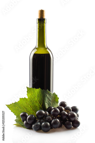 Bottle of red wine. leaves of grapes a bunch of grapes. On white, isolated background.