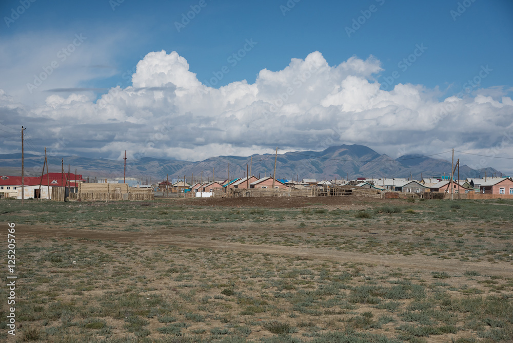 Altai village in the desert and sky with clouds in summer