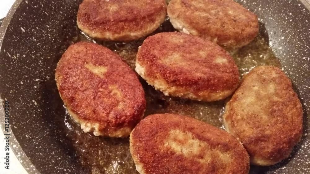 Fresh fried cutlets with oil in a frying pan
Fresh fried cutlets with oil in a frying pan