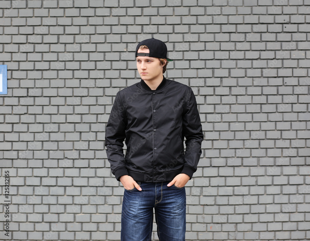 Attractive teenage boy in urban background Attractive teenage boy in urban background