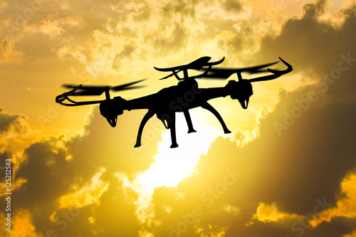 Drone flying in sunset landscape