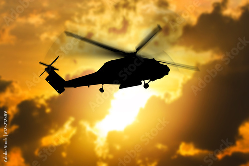 silhouette of helicopter with sunset.
