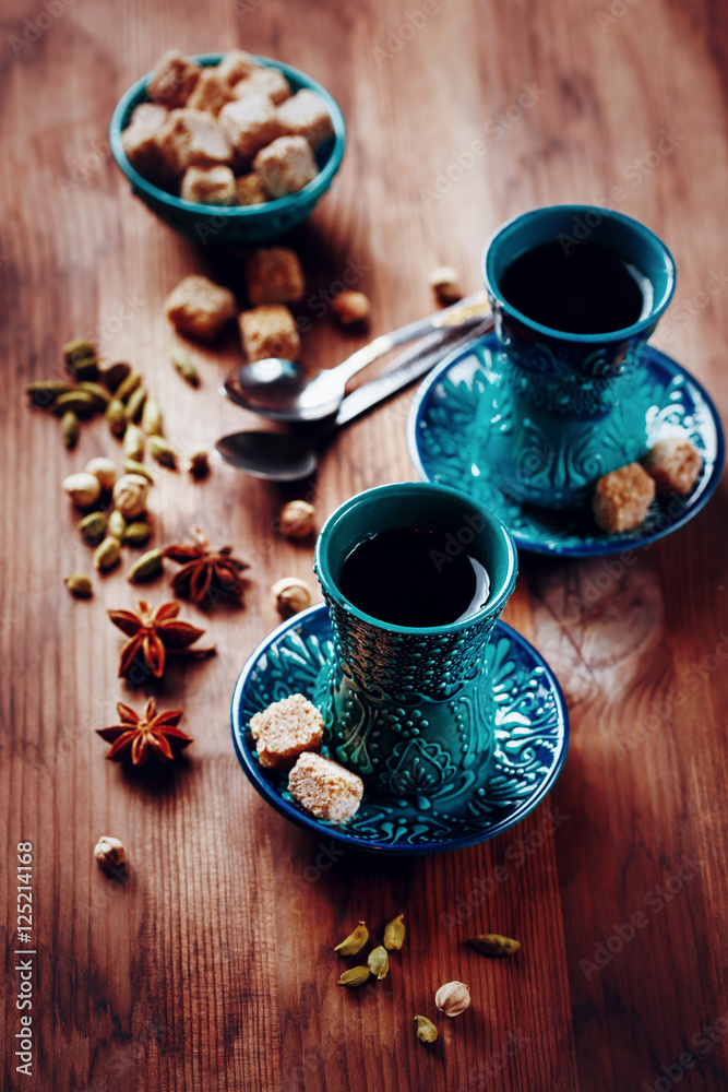Hot drink with spices in authentic glasses Hot drink with spices in authentic glasses