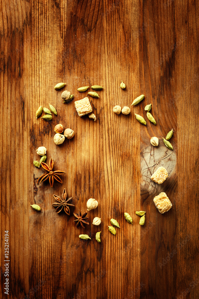 Food frame with spices on wooden background