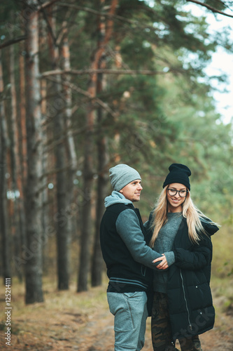 Portrait of young couple in love walking in beautiful forest enjoying hugging and smiling. Feelings, togetherness,friendship © victoriazarubina