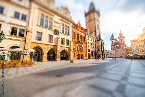 Cityscape view on the clock tower and Tyn cathedral during the sunrise in the old town of Prague