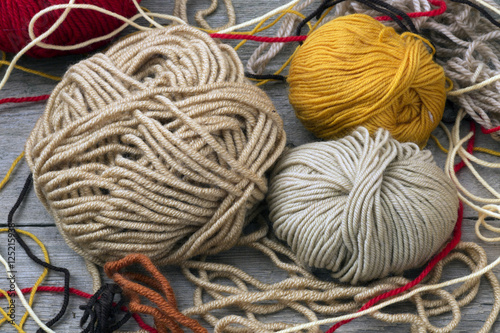 buttons, scissors and yarn on a wooden table