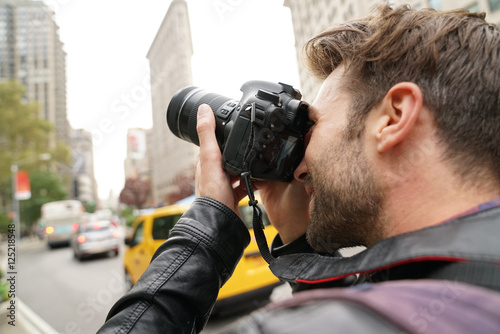 Tourist in New york city taking pictures with photo camera