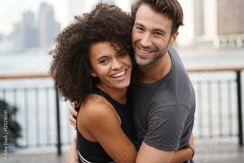 Couple in running outfit embracing each other
