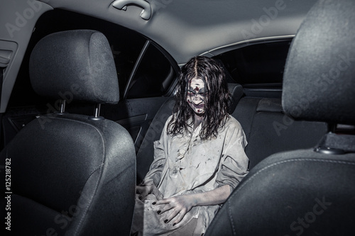 Horror zombie woman with bloody face in the car © Nomad_Soul