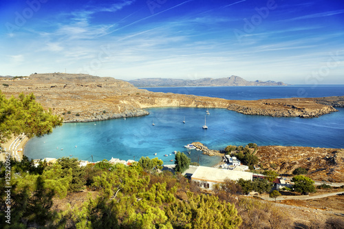 Beautiful sea landscape, green hills, blue sky and azure water.