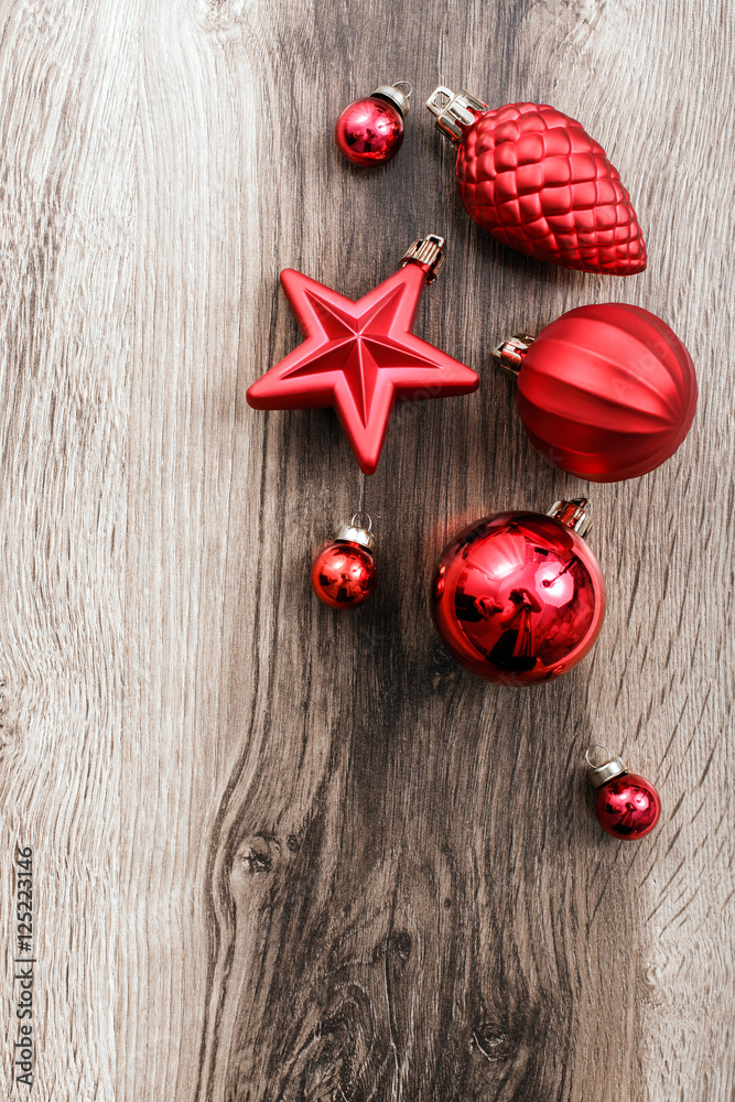 Christmas ornaments and fir tree branch on a rustic wooden background. Xmas card. Happy New Year. Top view with copy space Christmas ornaments and fir tree branch on a rustic wooden background. Xmas card. Happy New Year. Top view with copy space