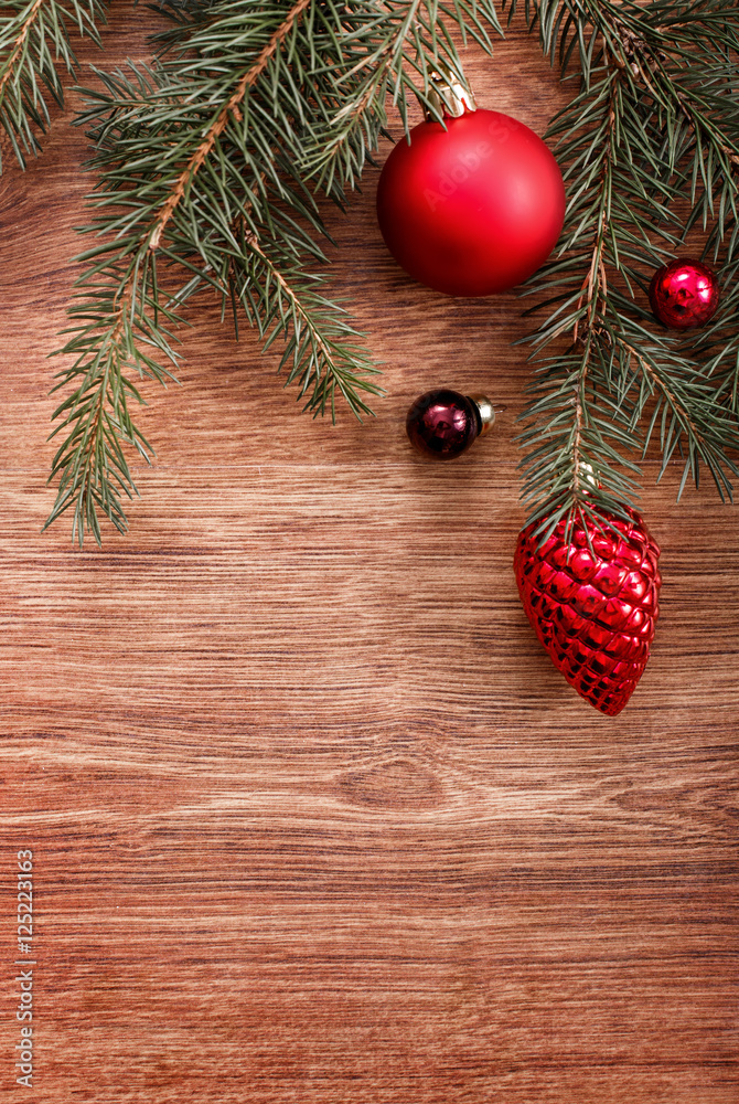 Christmas ornaments and fir tree branch on a rustic wooden background. Xmas card. Happy New Year. Top view with copy space Christmas ornaments and fir tree branch on a rustic wooden background. Xmas card. Happy New Year. Top view with copy space