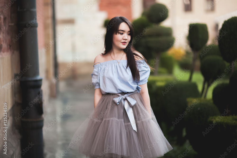 Young Asians girl with modern dress posing in an old Krakow Young Asians girl with modern dress posing in an old Krakow