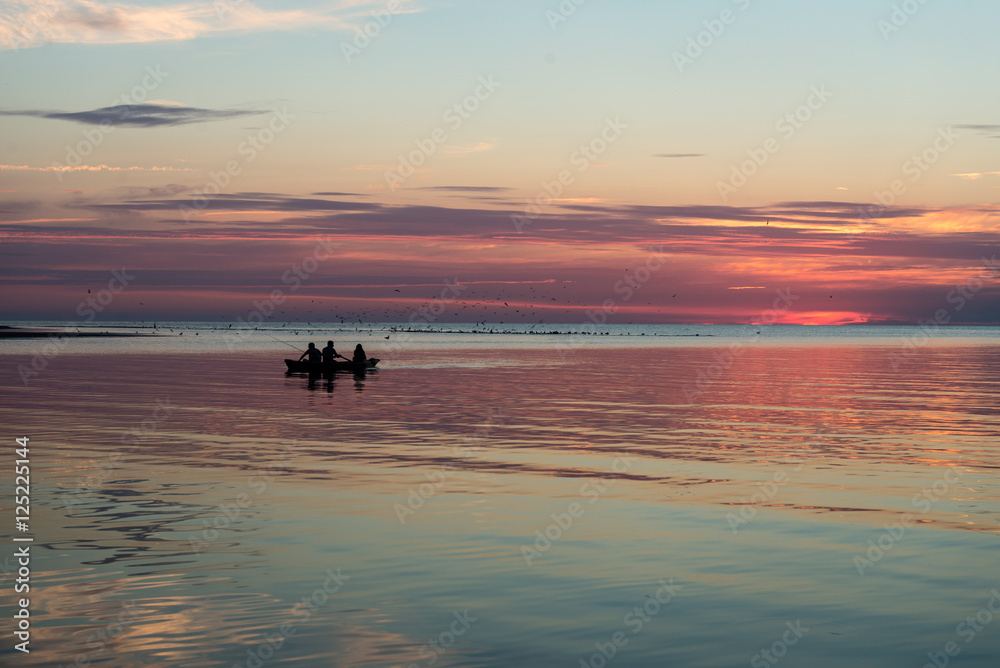 Obraz premium Reflections in the calm lake water with small boat