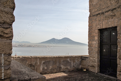 view of Vesuvius and gulf framed by the walls of Castel dell'Ovo, Naples, Italy  photo