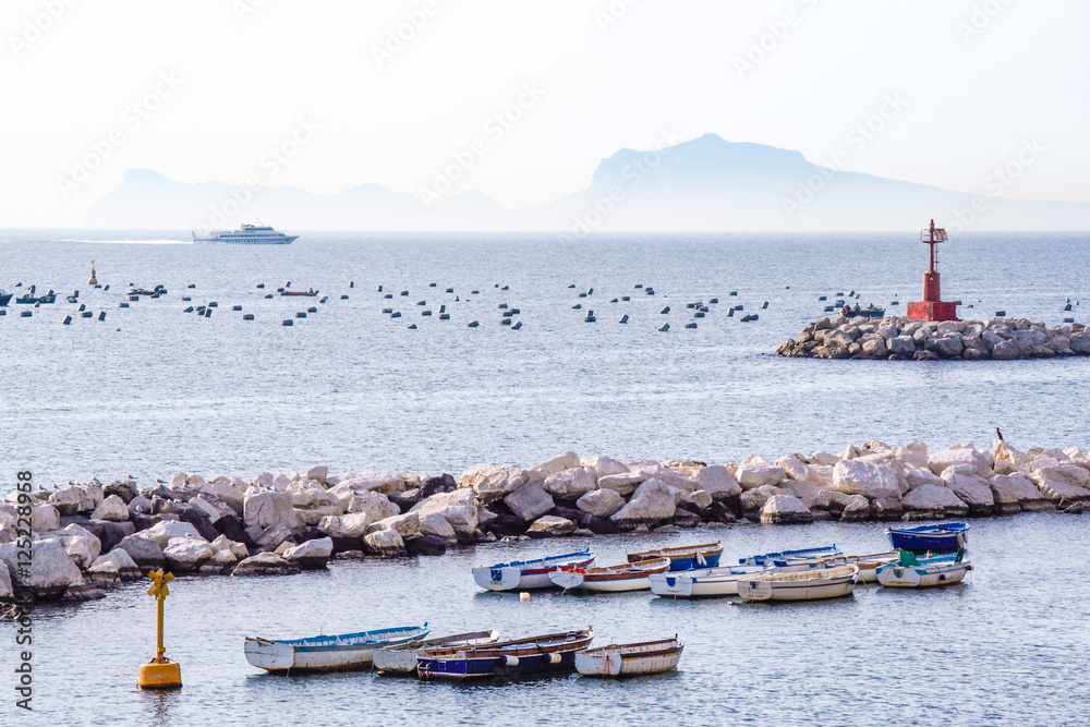Landscape of Naples gulf, fishermen's boats  and island of Capri