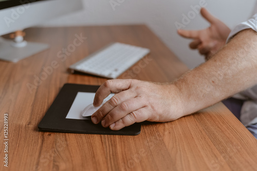 Closeup on person hands working typing, office desk background. Top view flat lay style