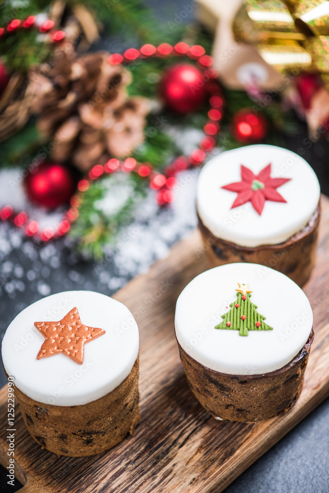 Traditional Christmas fruit rich cakes with decoration Traditional Christmas fruit rich cakes with decoration