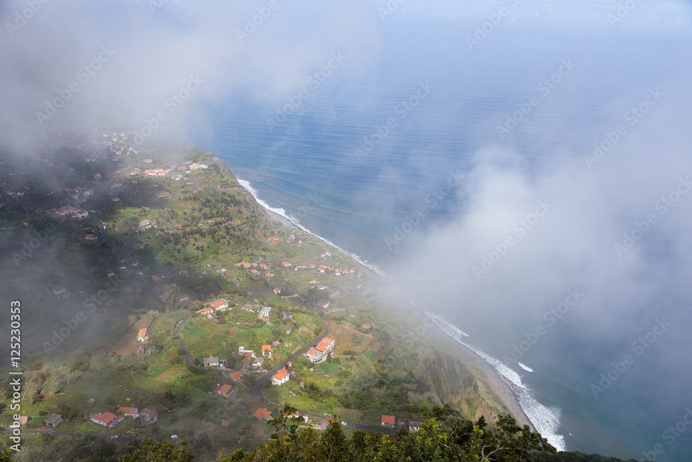 Aerial view through clouds from viewpoint Cabanas over Arco de Sao Jorge and the Atlantic ocean, Madeira, North coast, Portugal