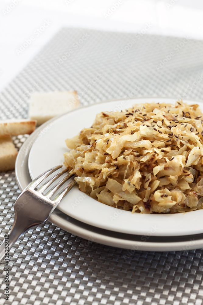 Fried cabbage with caraway and garlic on a plate Fried cabbage with caraway and garlic on a plate