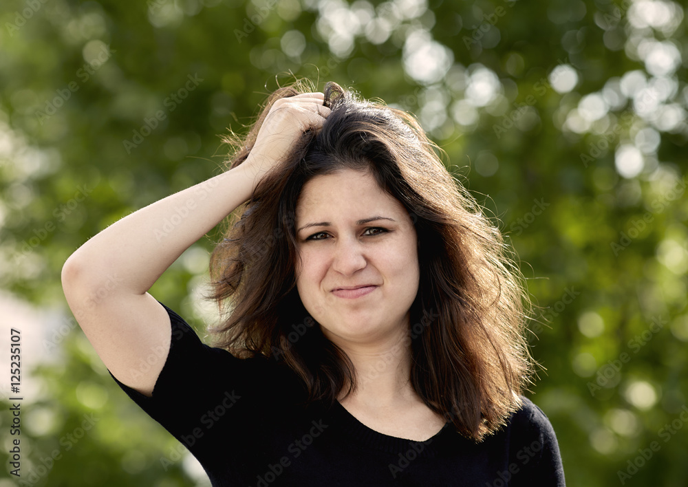 Young Adult Woman disgusted with her Hair
