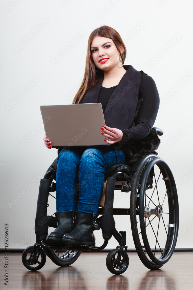 Disabled woman with laptop on wheelchair. Disabled woman with laptop on wheelchair.