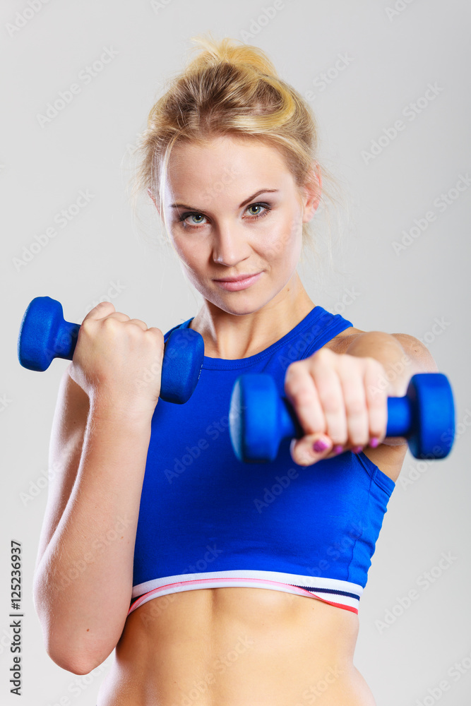 Fit woman lifting dumbbells weights Fit woman lifting dumbbells weights
